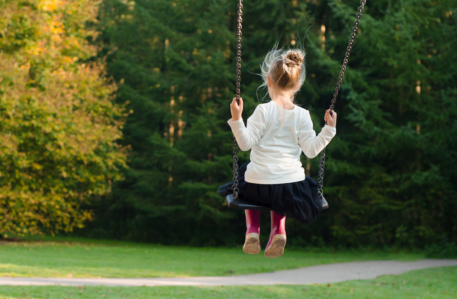Teach Your child to accept themselves image-girl on swing